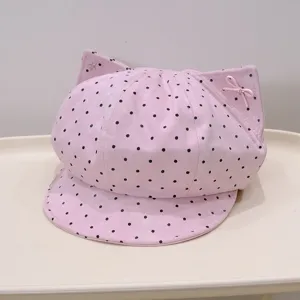 Cute pink polka dot cat ear painter hat close-up detail showing sweet bow and star accent.