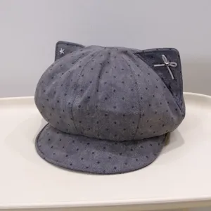 Detailed close-up of the grey polka dot cat ear newsboy cap showcasing cute bow and star.