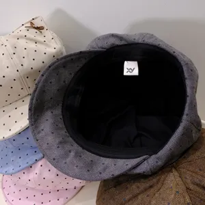 Detailed view of stylish polka dot octagonal painter hats stacked together, showing inner lining.