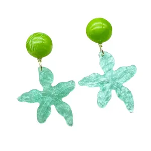 Close-up of summer beach style starfish dangle earrings with green marble beads