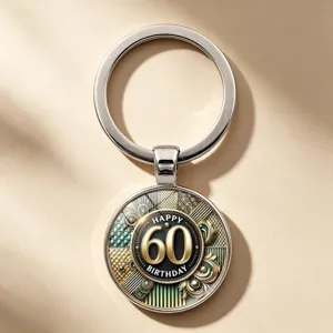 Detail of 60th birthday keychain featuring gold and black vintage pattern design
