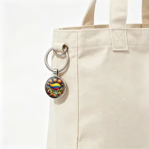 Close-up of Colombian flag fireworks keychain hanging on a beige canvas tote bag