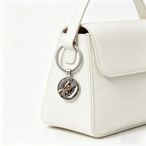 Vintage music keychain with piano and treble clef detail on a white bag