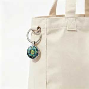 Detailed view of blue and gold mandala eight-pointed star keychain on a canvas bag
