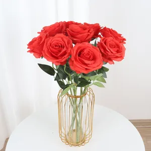 Artificial red silk roses in gold wire vase for home wedding decor