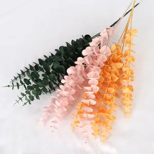 Artificial eucalyptus plastic flowers in green, pink and gold for home decor and weddings.