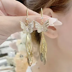 Elegant vintage golden butterfly earrings with sparkling cubic zirconia wing tassels.