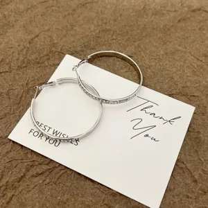 Elegant silver large hoop earrings with sparkling rhinestones for a stylish look