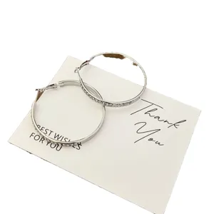 Elegant silver-toned hoop earrings embellished with sparkling clear rhinestones