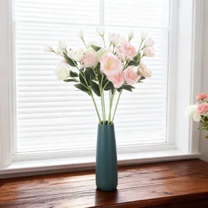 Elegant pink and white artificial Lisianthus flowers in a teal vase for home decor