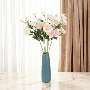 Artificial 4-head Eustoma flowers in a teal ceramic vase for home decor