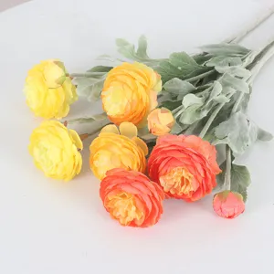 Kunstmatige geflokte ranonkelbloemen in geel en oranje voor huisdecoratie