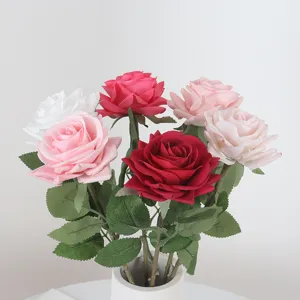 Multicolor artificial roses with green leaves in a white ceramic vase for home decor