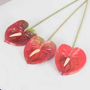 Artificial anthurium flowers with realistic red petals and green stems for home decoration