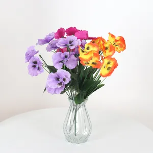 Colorful artificial pansy flowers in a glass vase for home and hotel decoration