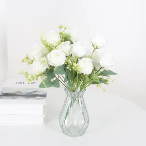 Artificial white roses bouquet in clear glass vase for home decor wedding party table