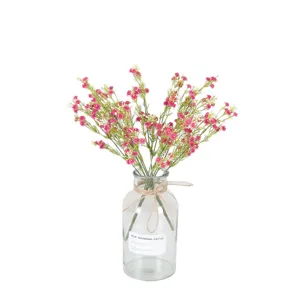 Artificial baby's breath flowers in glass vase with hemp rope bow for home and wedding decor.