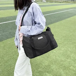 Black quilted travel bag, large capacity yoga duffel, casual shoulder handbag for outdoor trips.