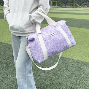 Casual fashion purple quilted travel bag and yoga duffel with white straps for gym trips.