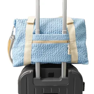 Casual blue travel duffel bag with luggage sleeve for short trips and gym workouts.