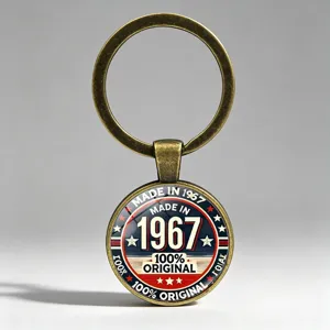Retro bronze metal keychain detail featuring 'Made in 1967' and '100% Original' text