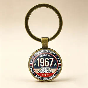 Macro view of a vintage bronze keychain featuring a "MADE IN 1967" original design label.