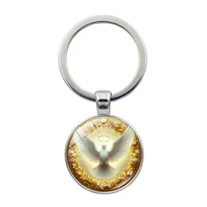 Silver metal keychain featuring a halo peace dove glass cabochon pendant for bags