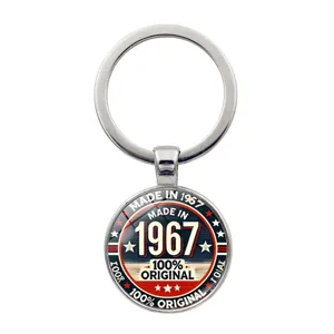 Vintage metal keychain featuring 1967 anniversary badge design on white background