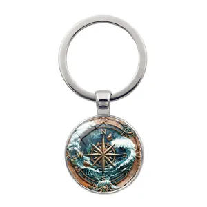 Vintage nautical compass keychain featuring ocean waves and sailboat design charm
