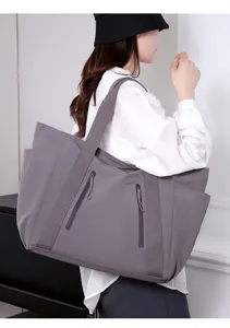 Grote grijze casual shopper tas met ritszakken aan de voorkant voor dagelijks gebruik.