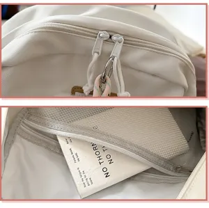 Detail view of white canvas backpack zipper and multi-layer mesh interior pocket storage.