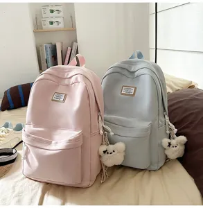 Detailed view of cute Japanese Harajuku style casual canvas backpack with plush pendant charm.