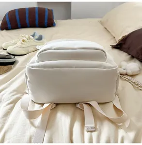 Casual white canvas backpack detail view, large capacity school bag for students.