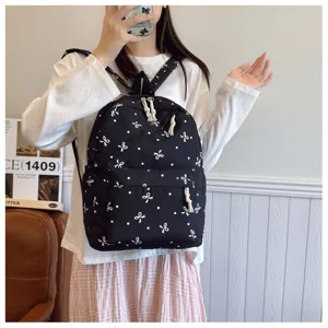 Mochila de lona negra con bonito estampado de lazos blancos y lunares, bolso casual escolar.