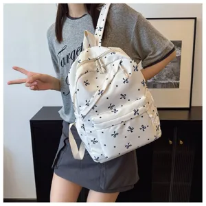 Mochila escolar casual de lona con bonito patrón de lazo azul para viajes diarios