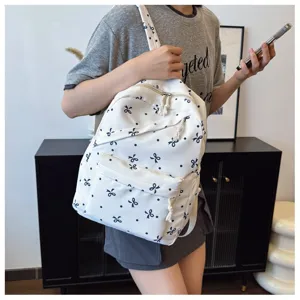 Mochila casual blanca con estampado de lazos para mujer, gran capacidad para escuela viajes.