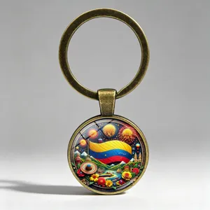 Close-up of vintage bronze keychain featuring Colombia flag scenery and fireworks art