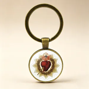 Detailed view of the Sacred Heart glass cabochon on an antique brass metal keychain