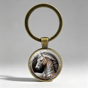 Macro view of vintage bronze keychain featuring an intricate horse relief pattern under glass.
