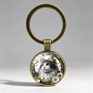 Detailed close-up of a vintage bronze keychain with a beautiful cat and flower graphic