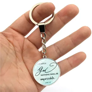 Detailopname van inspirerende metalen sleutelhanger met Bijbeltekst 'LUKE 1:37' erop.