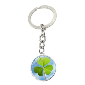Macro view of a silver keychain with a three-leaf clover glass cabochon pendant
