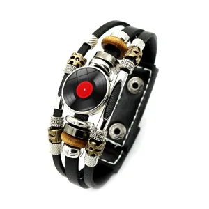 Detailed view of multilayer vintage punk leather bracelet with a retro vinyl record charm.