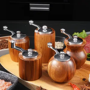 Handmade acacia wood manual pepper grinder and spice mill set for kitchen cooking and seasoning use.