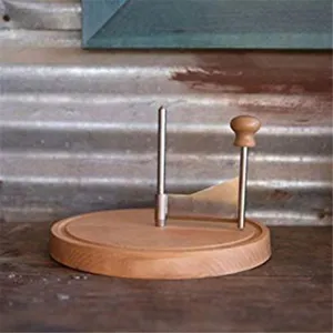 Manual cheese curler detail view, showing the wooden base, stainless steel blade and handle.