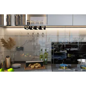 Detail view of a black iron hanging wine glass holder installed under modern kitchen cabinet.