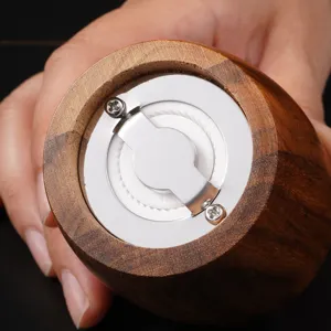 Acacia wood manual pepper grinder detail view, ceramic grinding mechanism for kitchen use.