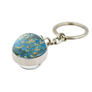 Detailed close-up of a glass dome keychain featuring Van Gogh's Almond Blossoms artwork