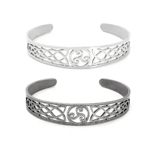 Detail view of two vintage Viking Celtic knot hollowed stainless steel cuff bracelets for unisex