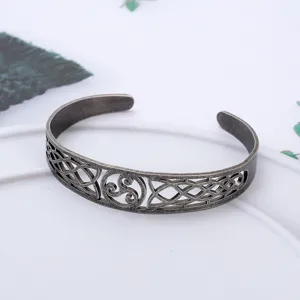 Macro detail of a vintage Viking Celtic knot hollow titanium steel open cuff bracelet